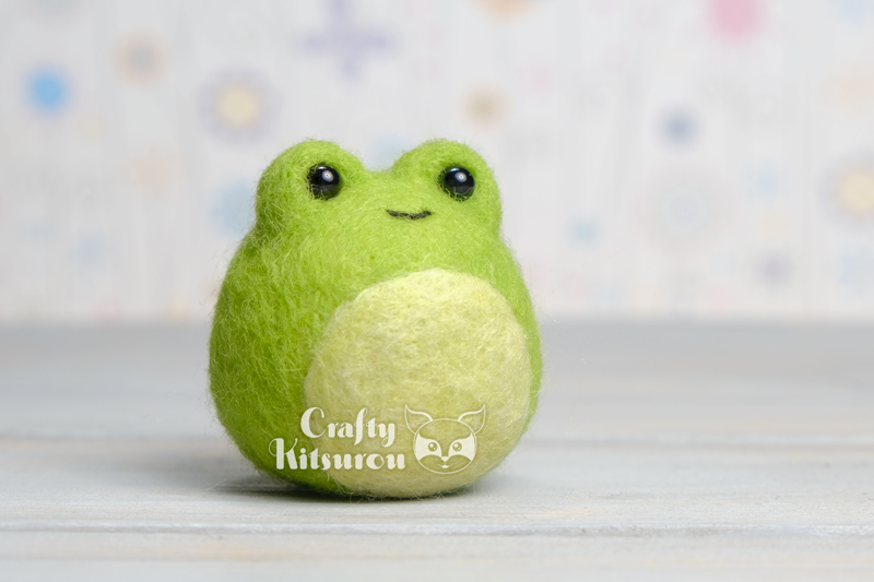 Needle felted figure of a green frog.