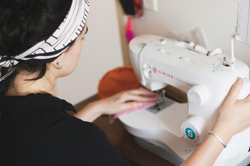 Woman using a sewing machine.